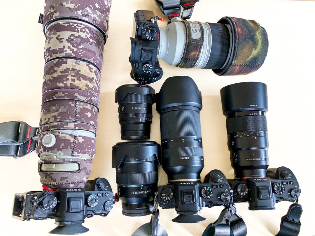 4x cameras and 6 lenses on a table