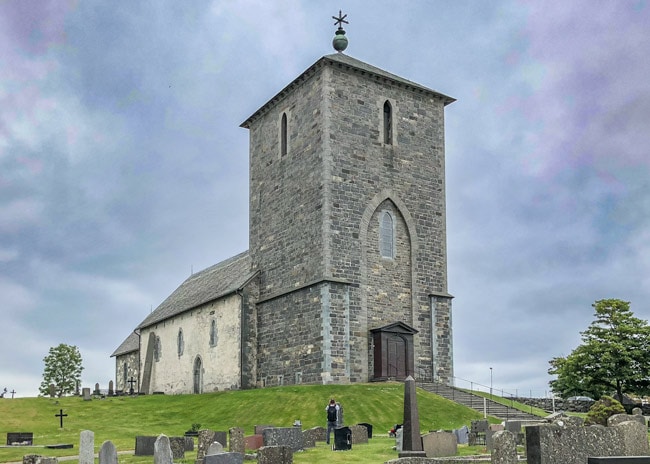 St Olav's church on the hill with a post almost touching the side