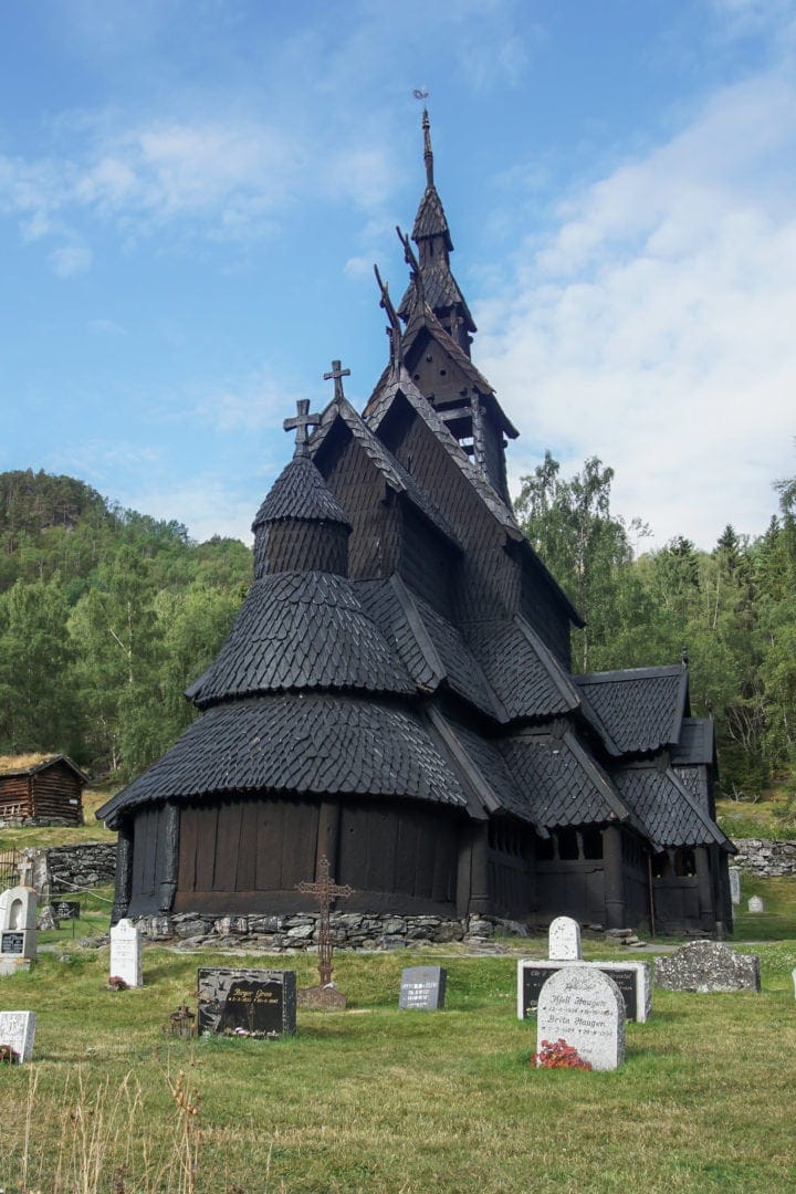 black wooden stave church on a small hill