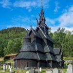 Black Stave church with a green forest behind it