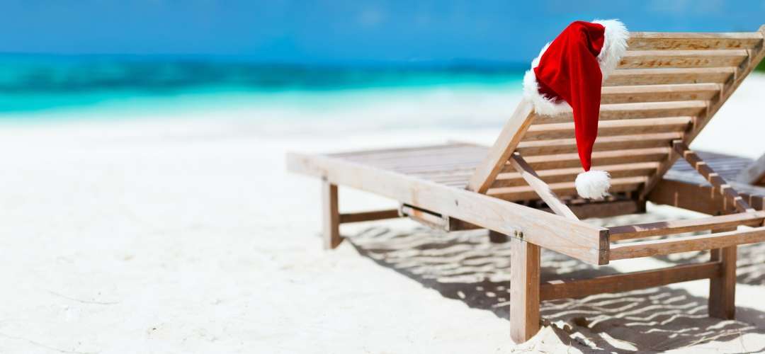 Christmas hat on a sunbed at the beach 