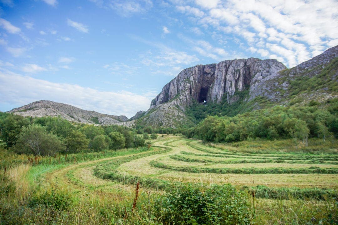 Harvested-fields-in-front-of-a mountain with a hole in it