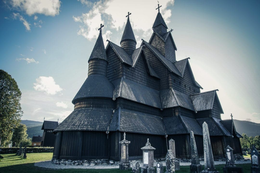 Heddal stave church with sun backdrop