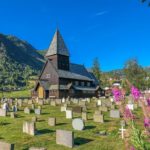 stave church in a green grassed cemetery