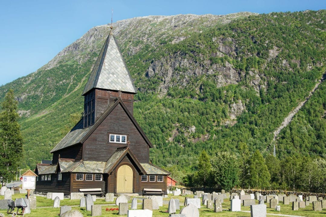 Wooden stave church in a mountain setting