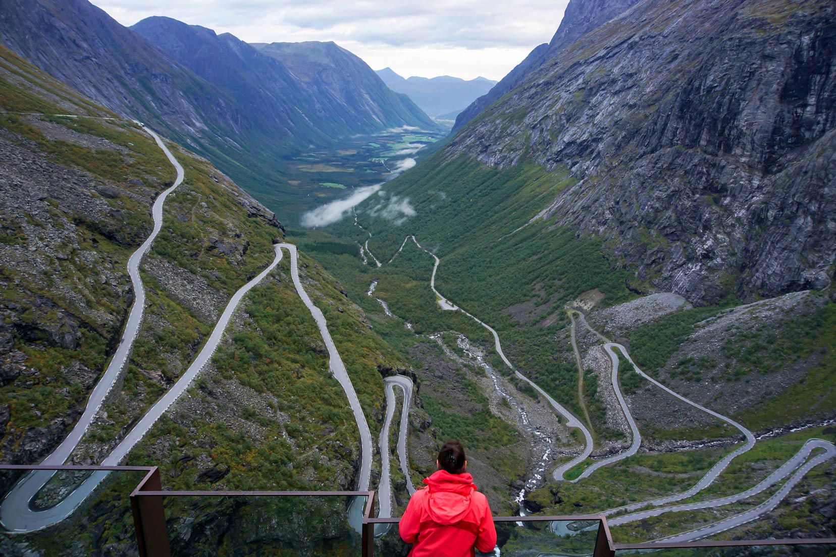 Shelley-at-Trollstigen,-Norway looking at a winding road through the mountains