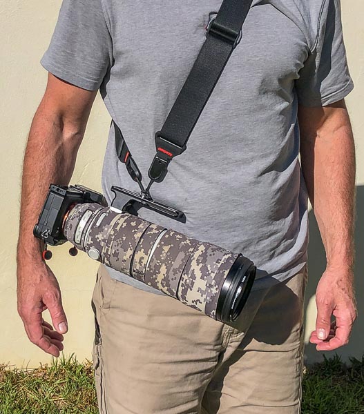 Sony camera and lens carried with a shoulder strap