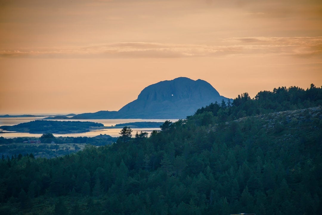 Sunset over a mountain with a hole in it