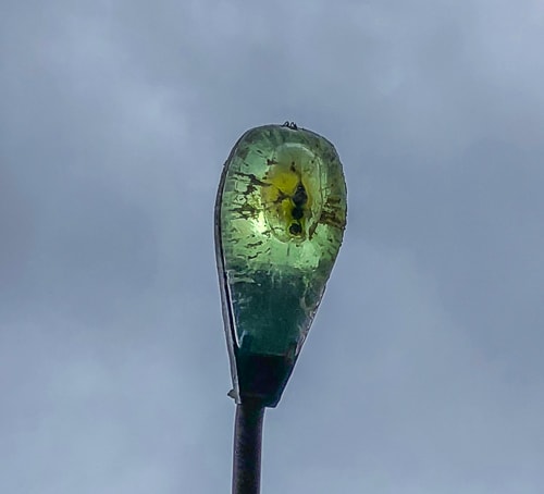 Geocache with a face on a lamp light