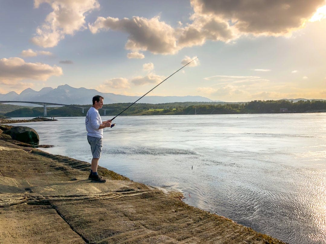 man fishing at a river