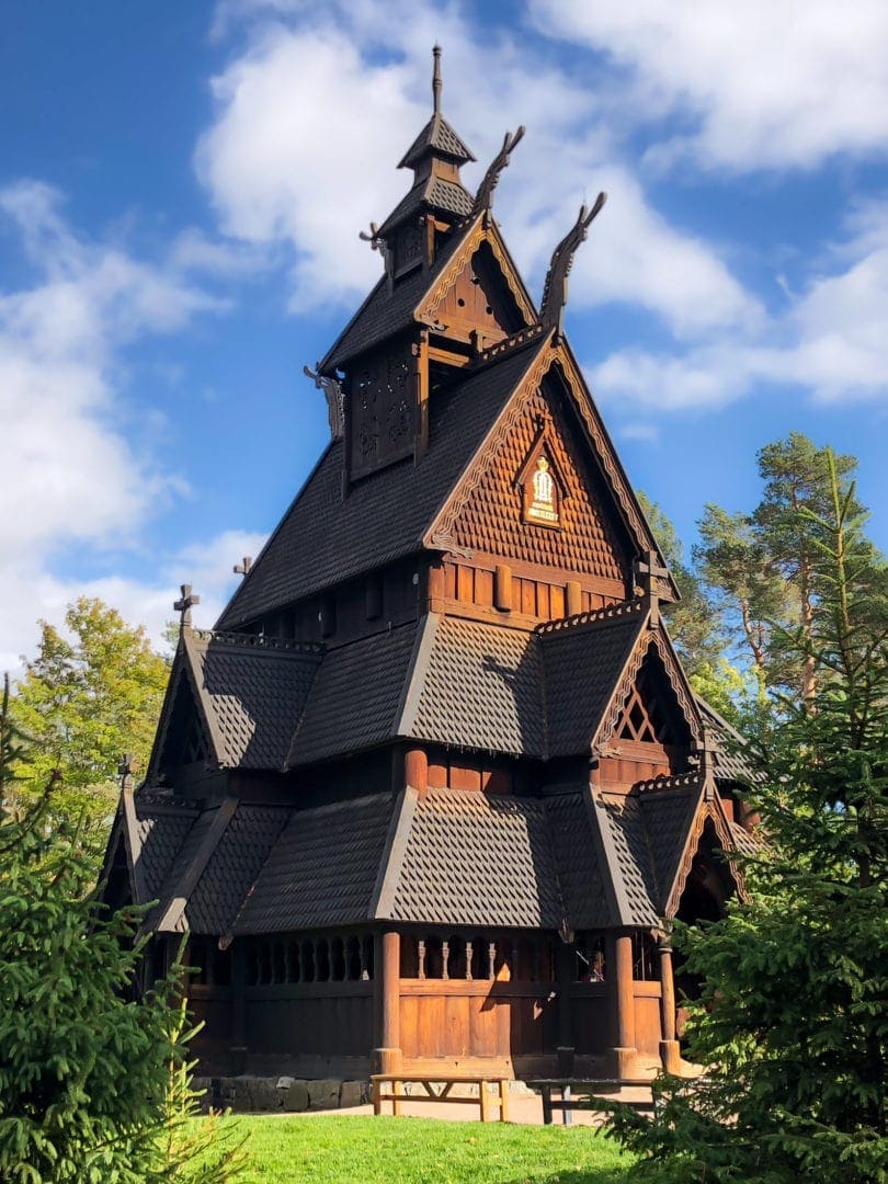 wooden stave church amongst pine trees