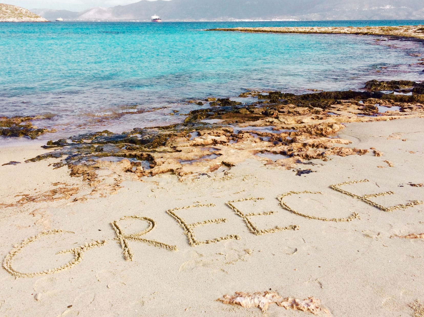 Reasons to visit greece writing in sand 