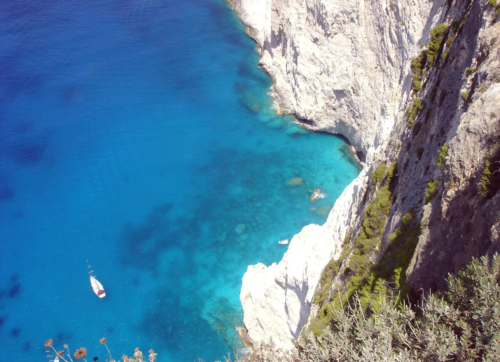 Greek Islands ariel view rock with a boat in the ocean