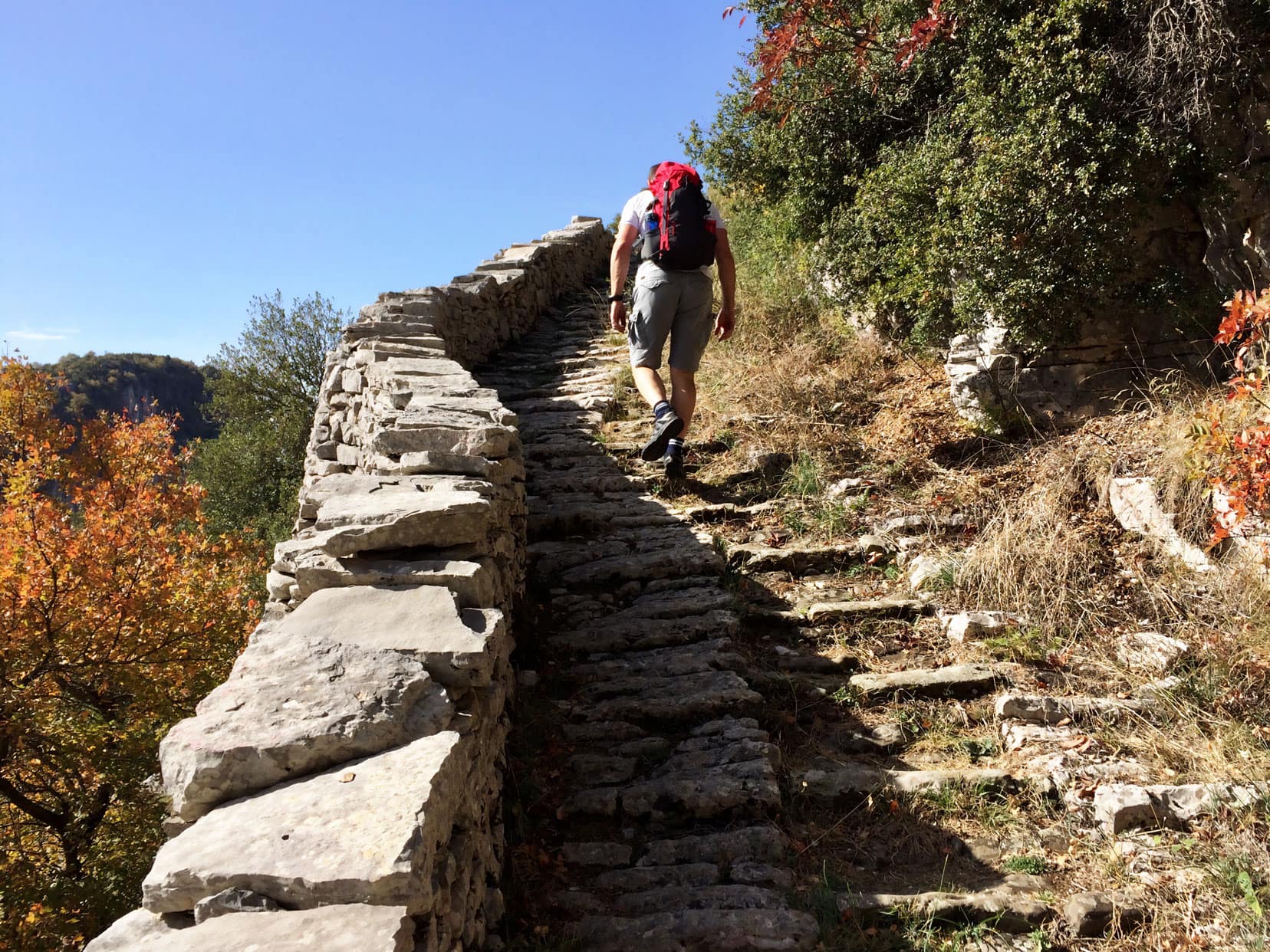 Lars climbing stone steps at Vicos Gorge in Greece