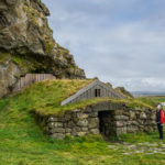stone hut with grass as a roof backing onto a mountain in Iceland