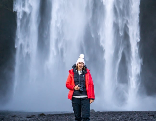 standing seemingly underneath Skogafoss waterfall, Iceland