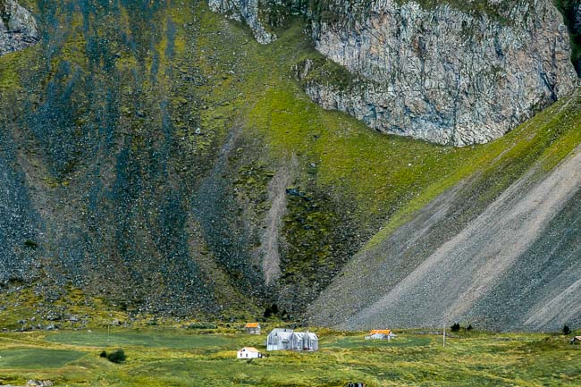 home under a steep volcanic mountain in Iceland