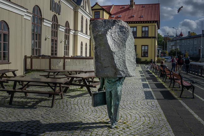 the unknown bureaucrat statue of a man with a lump of stone as his top half , Iceland