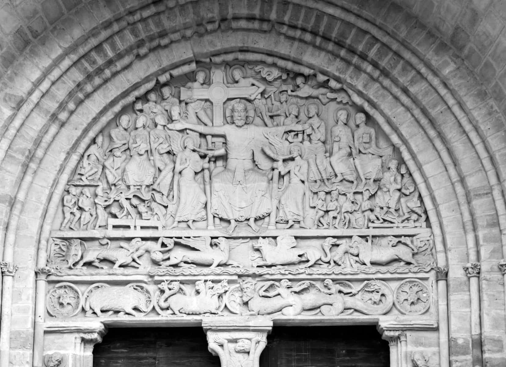 sone carving of christ and 12 apostles above the door of the Abbaye Saint Pierre in Beaulieu sur Dordogne 