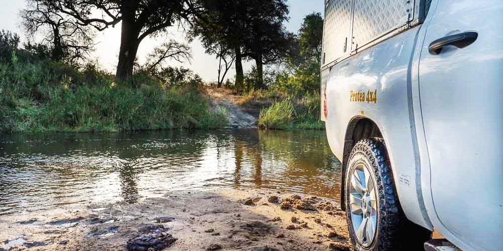 side of bush camper in a river crossing in the south african bush
