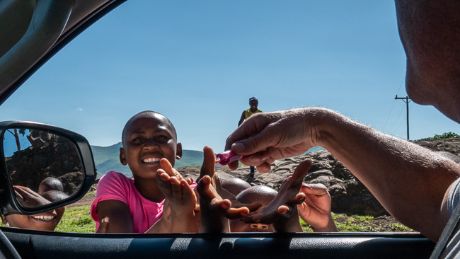 kids with hands out for bonbons