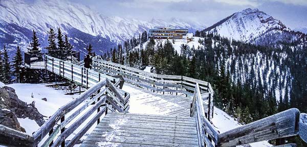 View-from-Sulphur-Mountain-Banff viewer can see wooden bordwalk and snowy mountains in the background