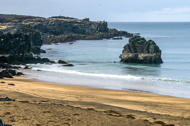 Beach with yellowish sand and rocky shore