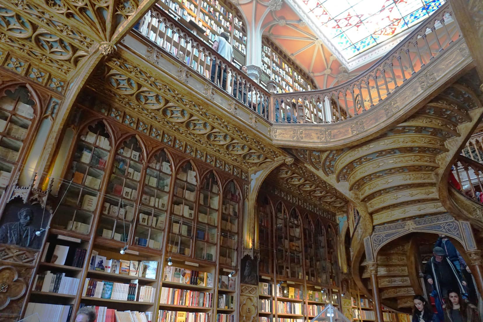 Wooden intricately desgned and carved book shelves with floor to ceiling books and two stories Book shop 