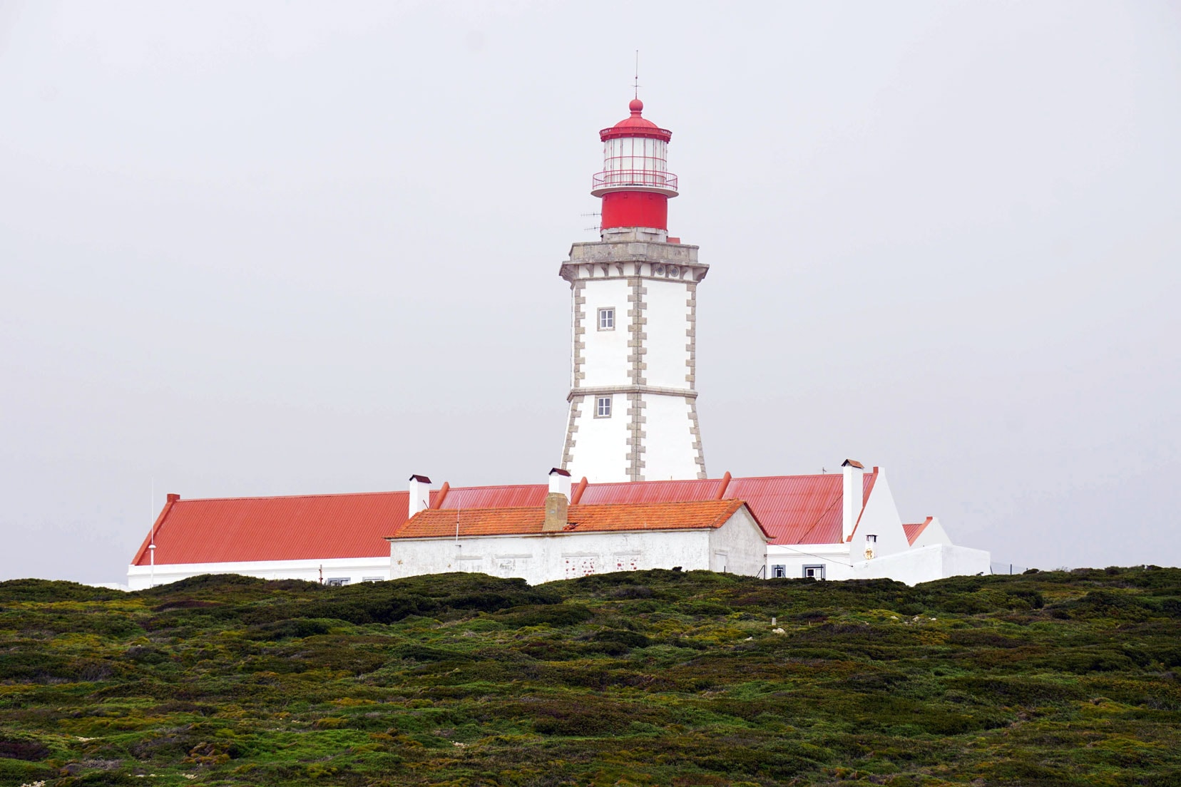 Cabo-Espichel-Lighthouse - a hexagonal red and white building