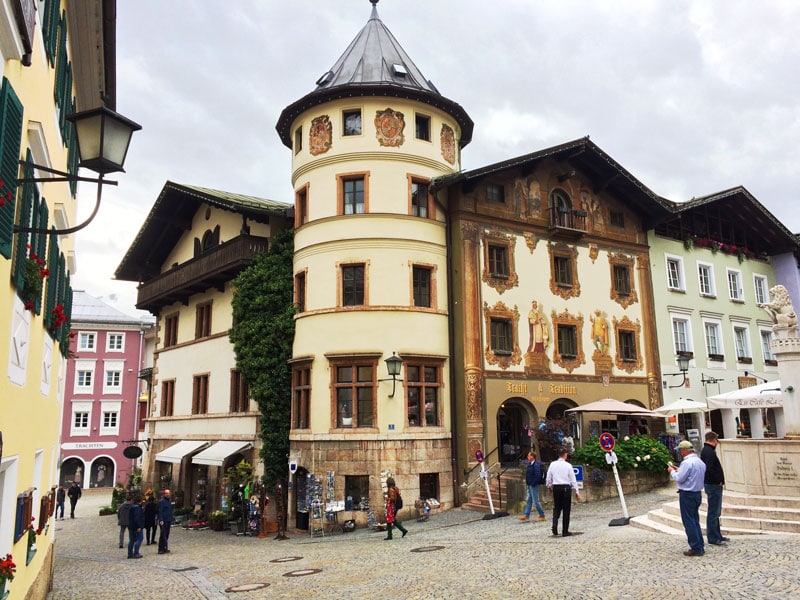 cream and brown buildings in Berchtesgaden with paintings around the windows