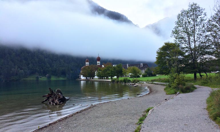 Konigssee-lake with the red and white chuch in the background view-through-fog