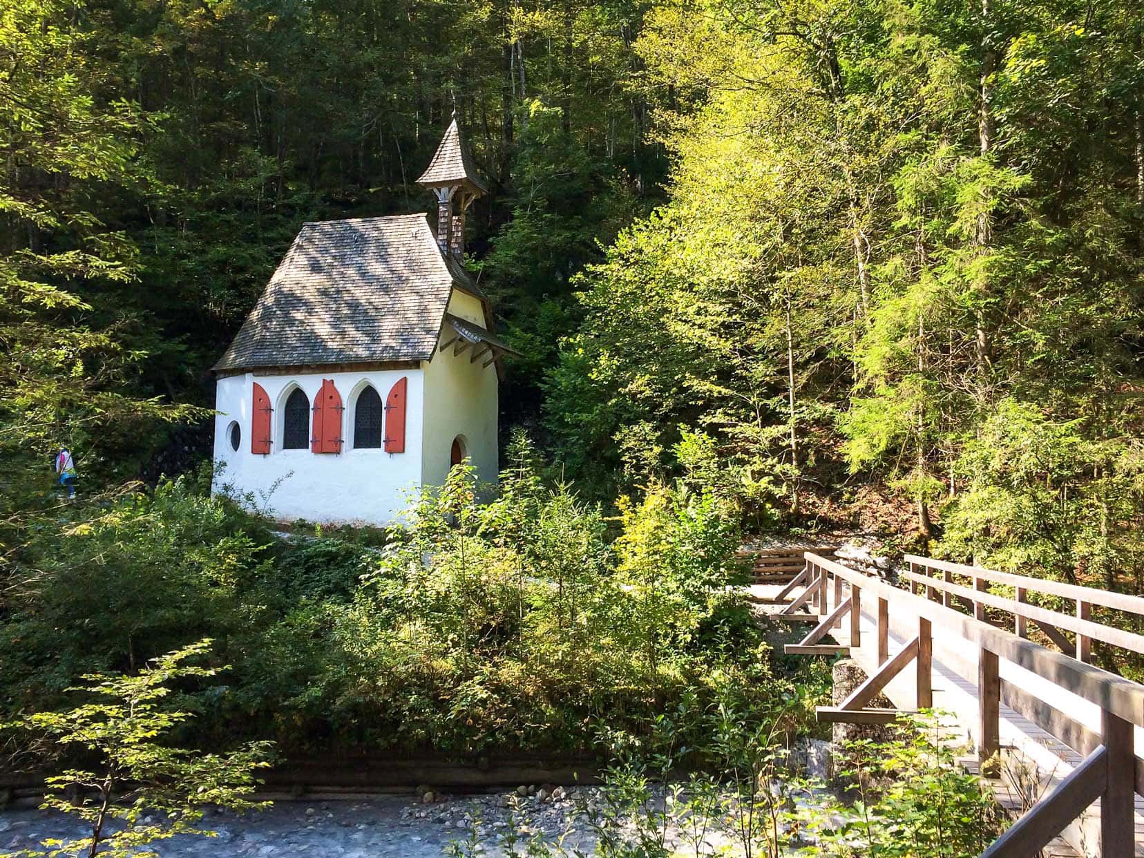 St Johann and Paul Chapel at Lake Konigssee - a small white walled chapel with red shutters either side of two arched windows