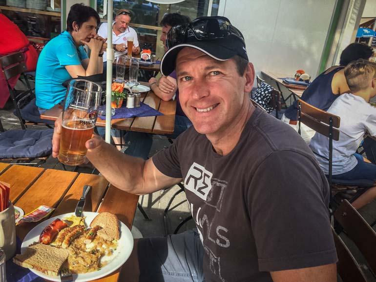 Man eating sausage at a cafe in Munich