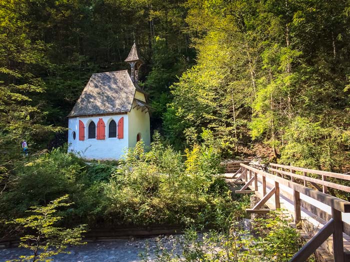St-Johann-and-Paul-Church at Lake Konigssee - a red and white small building by a small wooden bridge