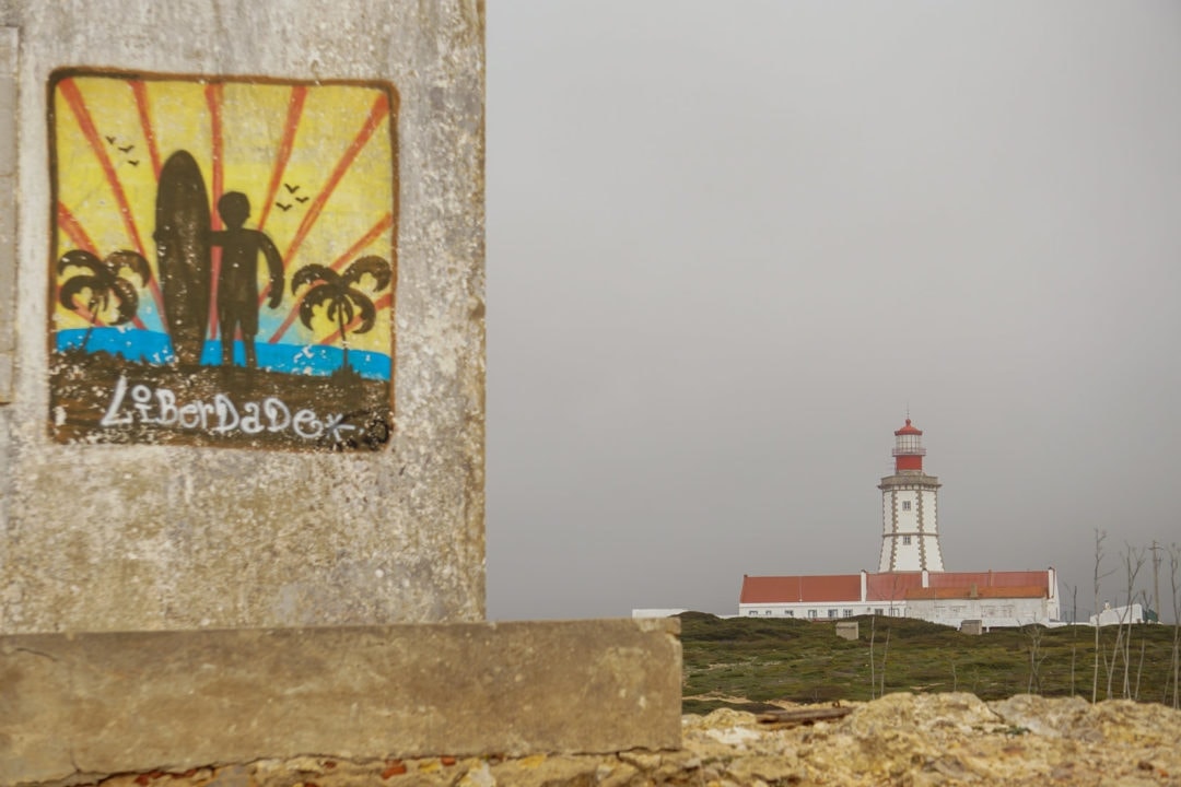 art on a nearby  building with cabo espichel lighthouse.