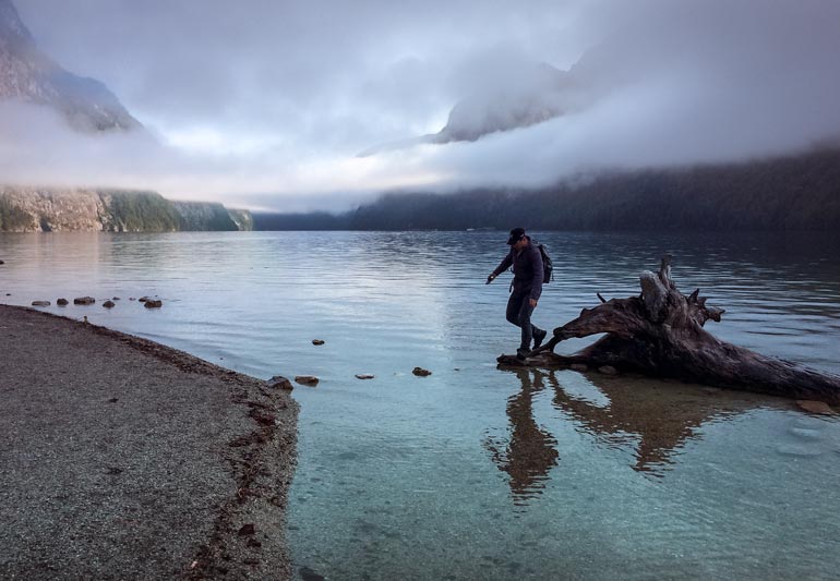 Mist over Konigssee Lake with lars hopping across stepping stones
