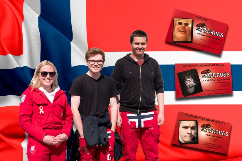Three students dressed in red overalls with norwegian flag behind them