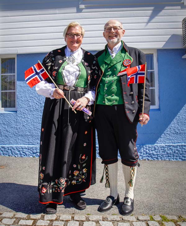 man and woman dressed in bunads