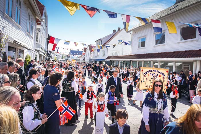 street parade in Skudeneshavn Norway on May 17th with lots of children and adults dressed in bunads