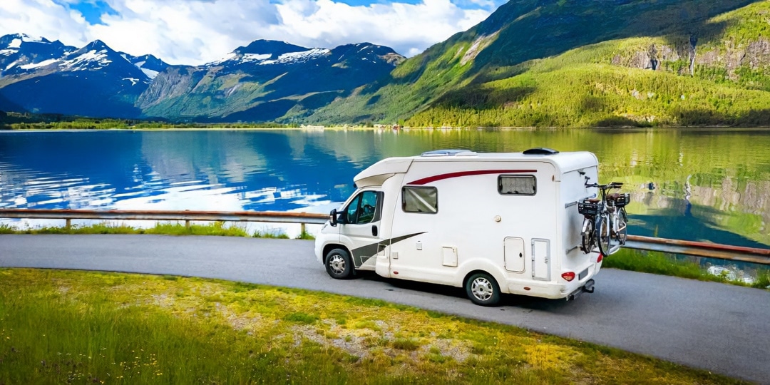 Hiring-a-motorhome-Header motorhome on a road by lake and mountains