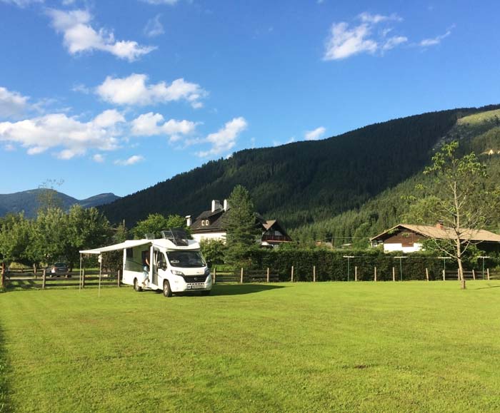 motorhome with awning out in a green field