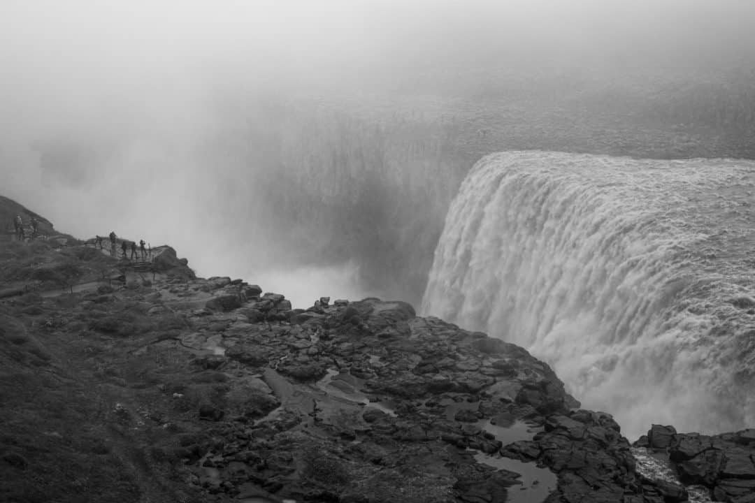 Breathtaking Icelandic landscapes__Detifoss with a few people that look tiny on the opposite cliff