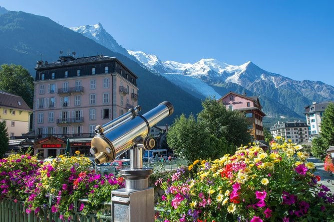 Village of Chamonix with flowers in foreground and mountains in the background. 