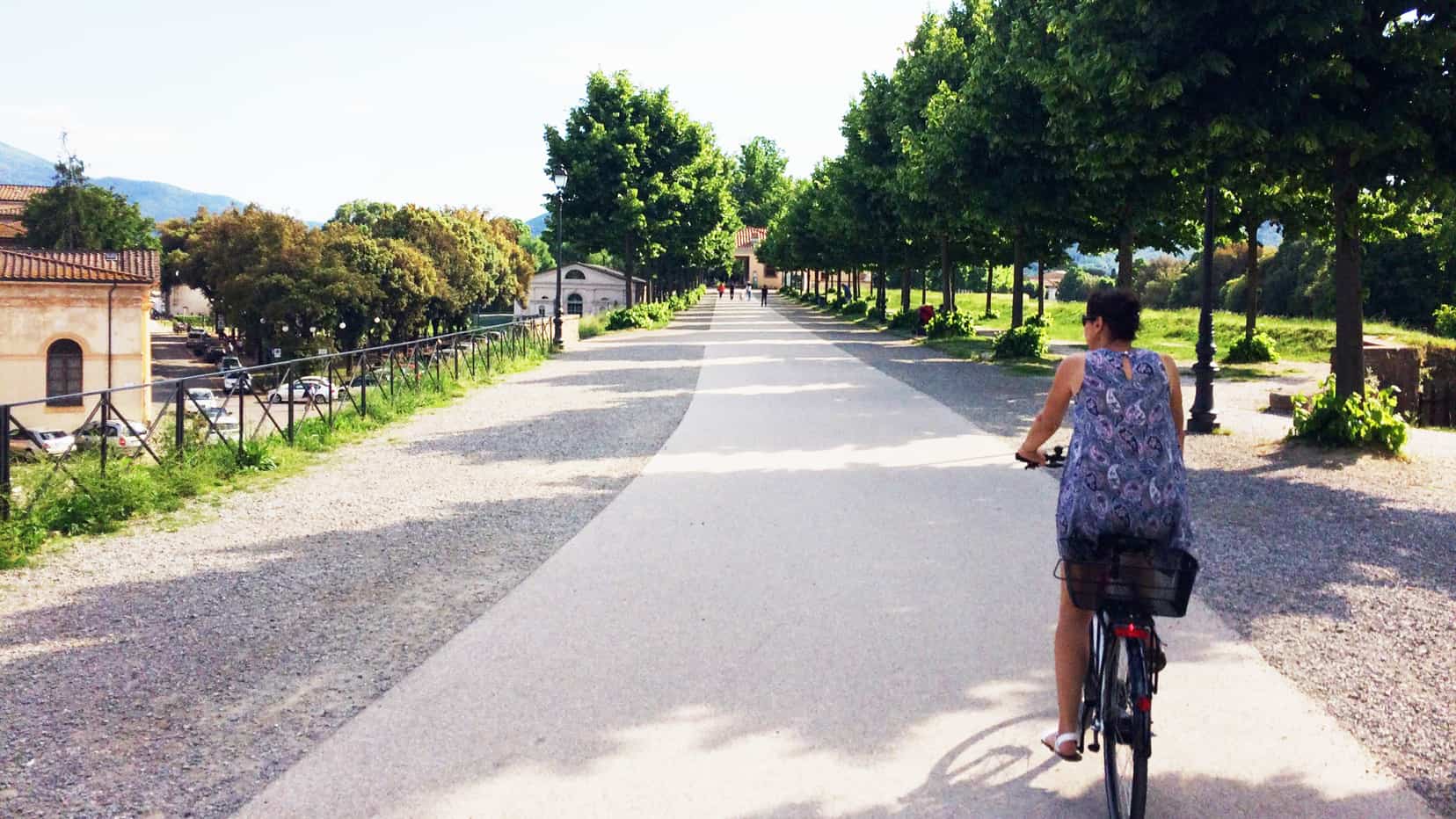 woman riding bike in Lucca