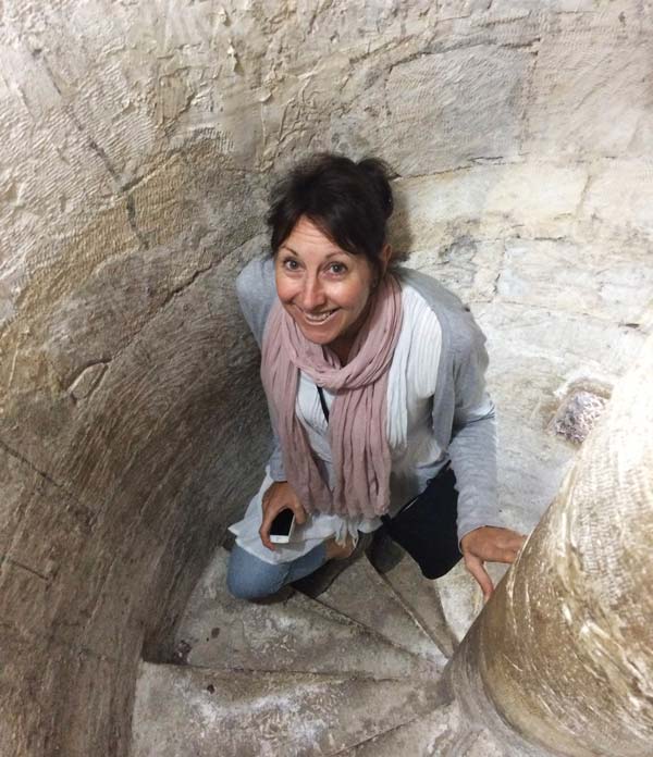 woman in spiral stone staircase