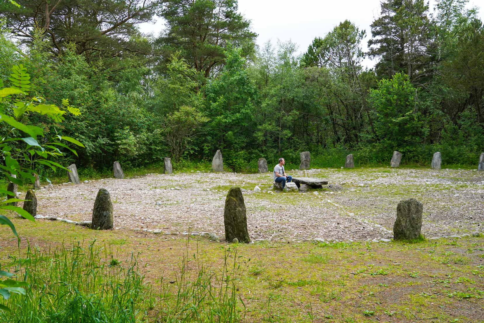Lars sat on the centre stone of the circle of ancient granite stones in a clearing of woodland