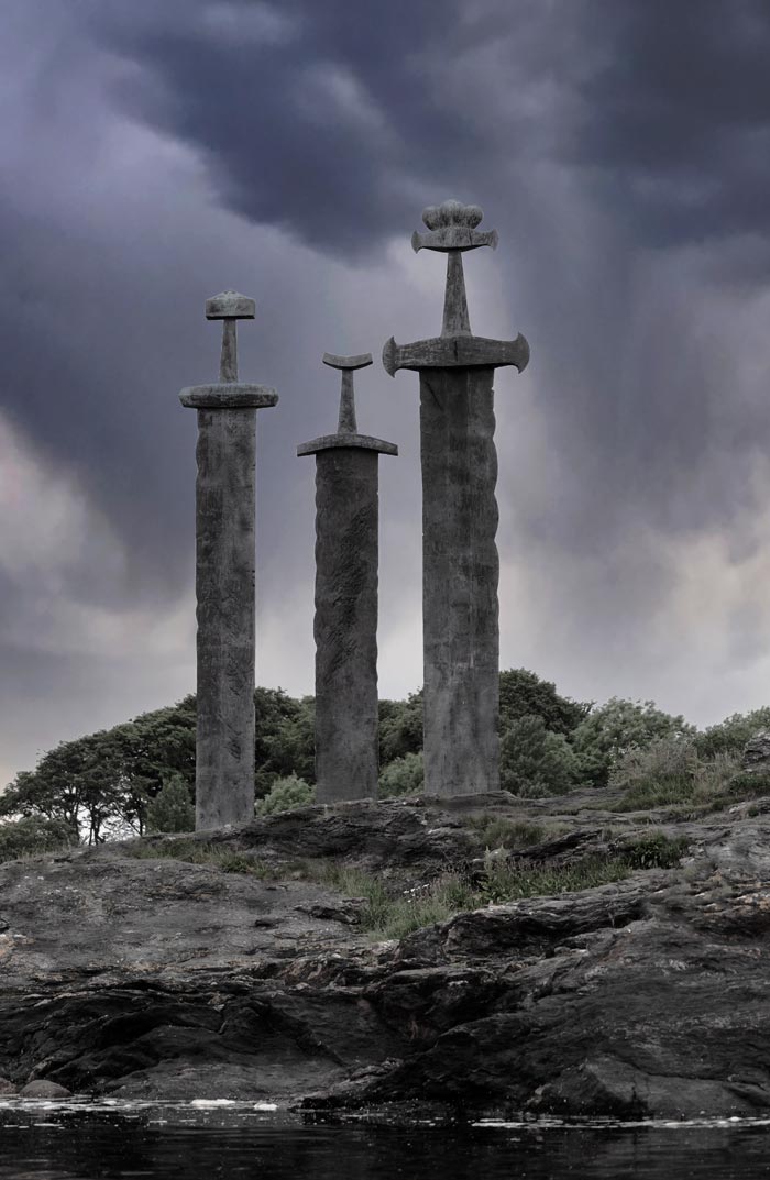 Three metal swords embedded in the rock below in stavanger