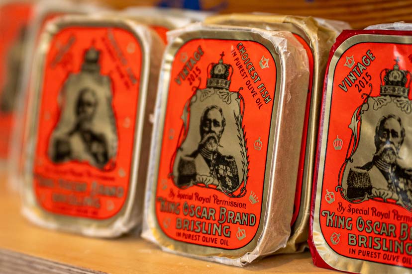 sardine cans with a red wrappig with a picture of the king on it