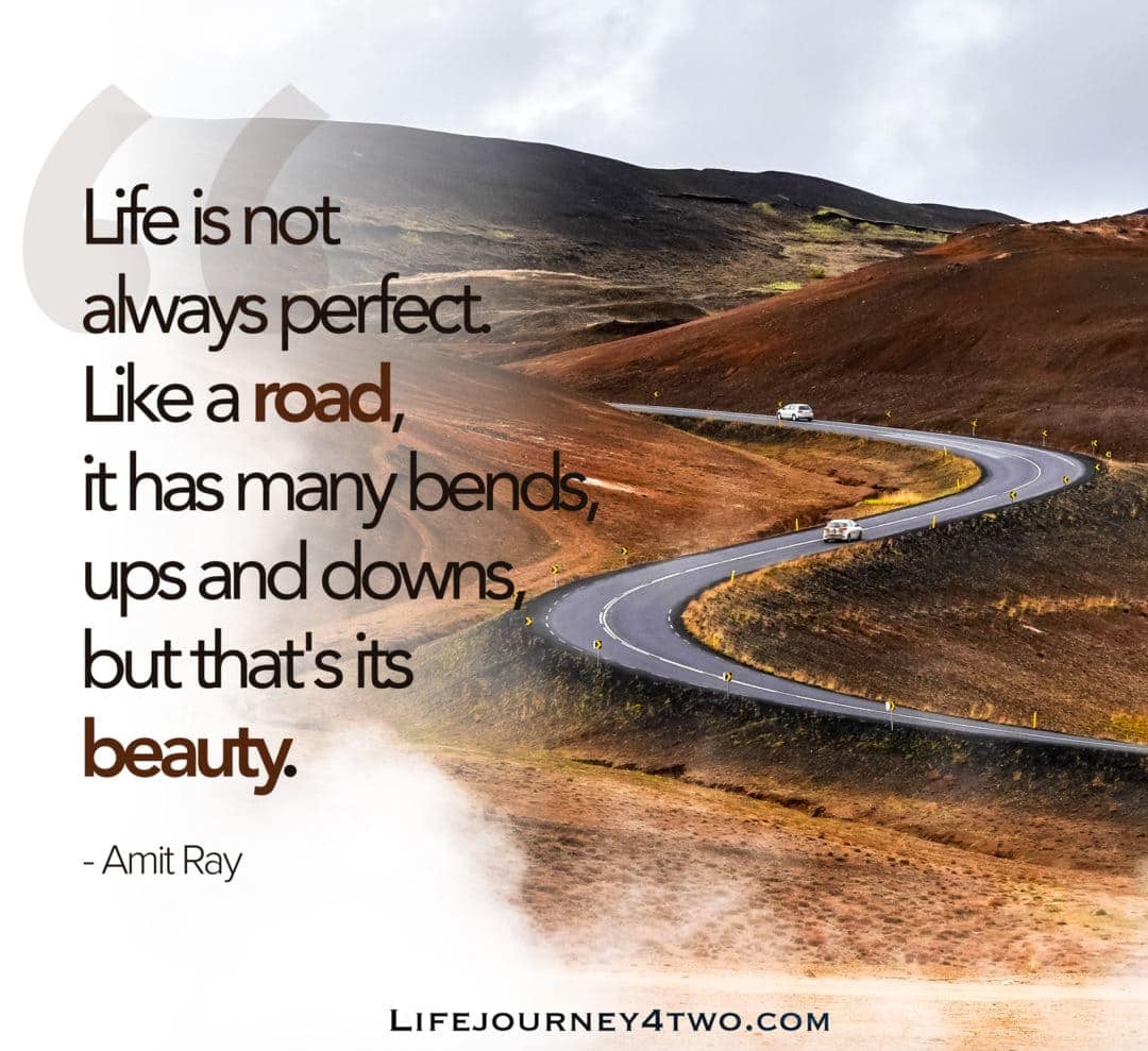 quote on a windy road between brown mountains