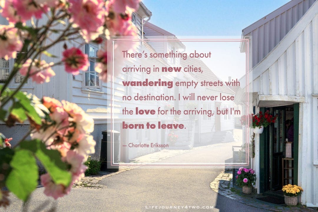 quote on image  of streeet with white timbered houses and roses
